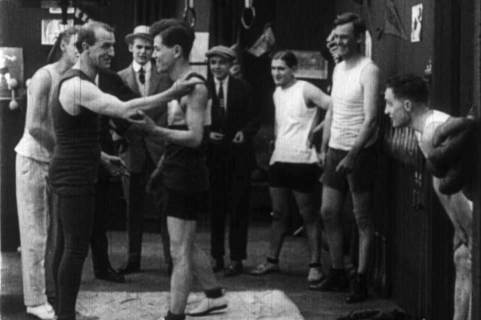 men in the gym with others watching